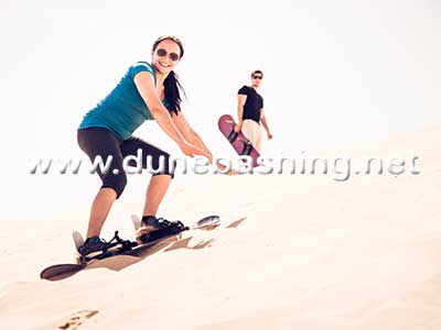 sandboarding in morning Desert Safari Dubai